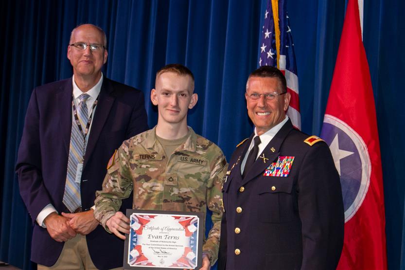 A student is honored for serving in the US Armed Forces after high school